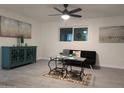 Living room featuring gray tile floors, a ceiling fan, and modern decor at 418 W Hartford Rd, Kearny, AZ 85137