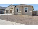 Attractive single-Gathering house showcasing a tidy gravel yard and a side-entry two-car garage at 12391 E Bahia Ct, Florence, AZ 85132