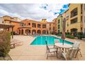 Gorgeous community pool with lounge chairs and seating area available to residents at 14575 W Mountain View Blvd # 11113, Surprise, AZ 85374