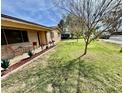 Charming single-story brick home featuring a well-manicured lawn and inviting curb appeal at 517 N Fraser Dr, Mesa, AZ 85203