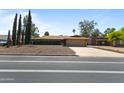 Charming single-story home featuring tidy shrubbery, a two-car garage, and desert-style landscaping at 848 S Revolta Cir, Mesa, AZ 85208