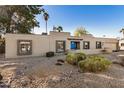 Front view of a single-story house with drought-tolerant landscaping at 6511 E Presidio Rd, Scottsdale, AZ 85254