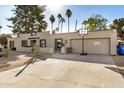 House exterior showcasing a driveway, garage, and basketball hoop at 6511 E Presidio Rd, Scottsdale, AZ 85254