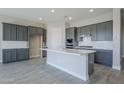 Modern kitchen with gray cabinets and quartz countertops at 16367 W Morning Glory St, Goodyear, AZ 85338