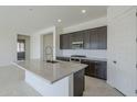 Modern kitchen with granite countertops and stainless steel appliances at 16417 W Desert Mirage Dr, Surprise, AZ 85388