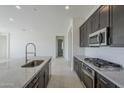 Modern kitchen with granite countertops and stainless steel appliances at 16417 W Desert Mirage Dr, Surprise, AZ 85388