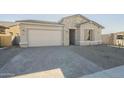 One-story home with stone accents and a two-car garage at 16425 W Desert Mirage Dr, Surprise, AZ 85388