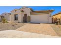 New construction home with a front yard and brick driveway at 266 S 165Th Ave, Goodyear, AZ 85338