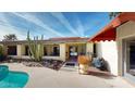 Relaxing patio area adjacent to the pool, offering outdoor entertaining space at 1007 N Revere --, Mesa, AZ 85201