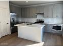 Modern kitchen with gray cabinets, island, and stainless steel appliances at 2200 N Iowa St, Chandler, AZ 85225