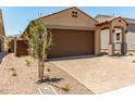 Lovely single-story home with a two-car garage, covered entry, and easy-care desert landscaping at 5656 N 205Th Ln, Buckeye, AZ 85396