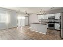 Modern kitchen featuring stainless steel appliances and island at 23559 W Wayland Dr, Buckeye, AZ 85326