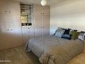 Bedroom with built-in wardrobe and a double bed at 10610 W Saratoga Cir, Sun City, AZ 85351