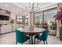 Elegant dining room boasts a modern chandelier and scenic views, perfect for intimate gatherings at 3800 E Lincoln Dr # 23, Phoenix, AZ 85018
