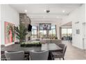 Open-concept living area features a cozy fireplace, high ceilings, and seamless integration with the dining space at 3800 E Lincoln Dr # 23, Phoenix, AZ 85018