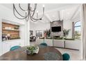 Stylish living space with dining and kitchen views, highlighted by a stone fireplace and an open layout at 3800 E Lincoln Dr # 23, Phoenix, AZ 85018