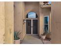 Double doors with screen doors leading into the home at 9478 E Corrine Dr, Scottsdale, AZ 85260