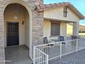 Covered front porch with stone facade and wrought-iron railing at 2101 S Meridian Rd # 205, Apache Junction, AZ 85120