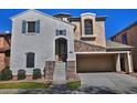 Inviting two-story house boasts a covered entry, stone accents, and well-maintained landscaping at 4232 E Tyson St, Gilbert, AZ 85295