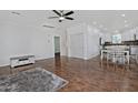 Spacious living room featuring hardwood floors, a ceiling fan, and an open floor plan at 4232 E Tyson St, Gilbert, AZ 85295