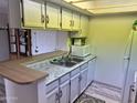 Galley kitchen with granite countertops and white cabinets at 540 N May St # 2109, Mesa, AZ 85201