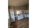 Bright updated kitchen featuring white cabinets and a modern sink at 5738 N 68Th Ave, Glendale, AZ 85303