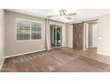 Spacious bedroom features a ceiling fan, sliding glass door, barn door and plush carpet at 14859 W Surrey Dr, Surprise, AZ 85379