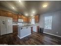 Modern kitchen with island, wood cabinets, and tile flooring at 650 N Hawes Rd # 3729, Mesa, AZ 85207