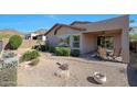 Relaxing backyard featuring a covered patio, desert landscaping, and mountain views at 27174 N 85Th Dr, Peoria, AZ 85383