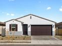 Beautiful single-story home with neutral colors, a two-car garage, and desert landscaping at 16038 W Desert Hollow Dr, Surprise, AZ 85387