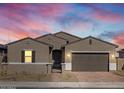 Charming single-story home with a two-car garage and a secure gated front entrance under colorful sky at 17672 W Pierson St, Goodyear, AZ 85395