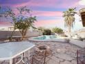 Backyard oasis with a sparkling pool, patio, and fire pit at 1342 N Mckenna Ln, Gilbert, AZ 85233