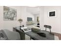 Stylish home office with large desk, modern art, and view of the living room at 21067 N Sequoia Crest N Dr, Surprise, AZ 85387