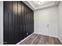 Modern entryway with black accent wall and wood-look floors at 4360 N 186Th Ln, Goodyear, AZ 85395