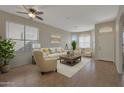 Bright living room featuring neutral tones, tile floors, lots of natural light, and stylish furnishings at 6520 W Oraibi Dr, Glendale, AZ 85308