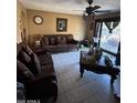 Living room features tiled floors, a comfortable sofa, and a ceiling fan at 2310 N 40Th Dr, Phoenix, AZ 85009