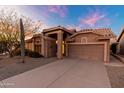 Single-story house with a two-car garage and desert landscaping at 8546 E Brittle Bush Rd, Gold Canyon, AZ 85118