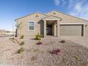 Inviting single-story home featuring a neutral stucco exterior, paver driveway, and low-maintenance desert landscaping at 5066 W Hunter Trl, San Tan Valley, AZ 85144