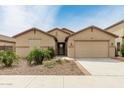 Charming single-story home with a desert landscape, two-car garage, and a welcoming entrance at 12121 W Patrick Ln, Sun City, AZ 85373