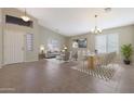 Bright dining room with a table and chairs, adjacent to the living room at 2946 E Quiet Hollow Ln, Phoenix, AZ 85024