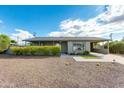 Ranch style home with carport, landscaped yard, and paved walkway at 3547 E Monterosa St, Phoenix, AZ 85018