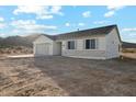 Well-lit single-story home with desert landscaping, a covered patio and a two-car garage at 13634 S 192Nd Ave, Buckeye, AZ 85326