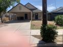View of the home's facade, featuring a covered carport, neutral paint and limited landscaping at 141 N Pasadena --, Mesa, AZ 85201