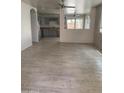 Open-concept living space with light wood-look flooring, opening to the kitchen at 141 N Pasadena --, Mesa, AZ 85201