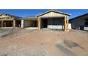 New single-story home with covered porch and unfinished landscaping at 22856 E Roundup Way, Queen Creek, AZ 85142