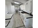 White kitchen with tile floor, island, and stainless steel appliances at 12601 S Hermit Rd, Buckeye, AZ 85326