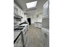 Bright kitchen with white cabinets, tile floors, and stainless steel appliances at 12601 S Hermit Rd, Buckeye, AZ 85326