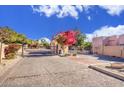 Gated community entrance with a mature tree and well-maintained landscaping at 6411 S River Dr # 26, Tempe, AZ 85283