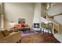 Living room with hardwood floors, fireplace, and spiral staircase at 6411 S River Dr # 26, Tempe, AZ 85283