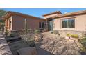 Lovely desert landscaping surrounds this home's entrance at 6486 E Oberlin Way, Scottsdale, AZ 85266